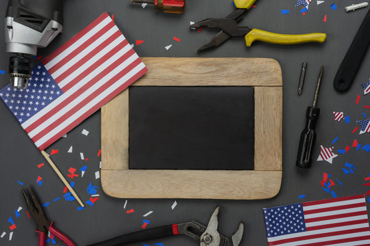 Table top view aerial image of decoration the sign of USA Happy labor day on Sep 3,2018 background concept. Flat lay accessories tools and US flag and mock up backboard on modern rustic grey wooden.