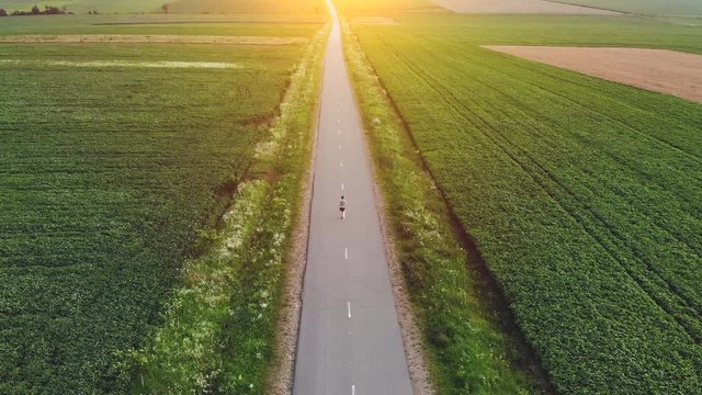 The sportsman running on a country road. quadrocopter shot