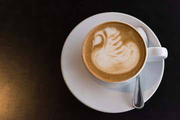 Flat white coffee cup on black table