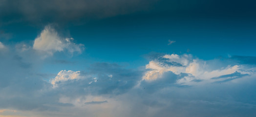 Landscape with dramatic light - beautiful golden sunset with saturated sky and clouds.