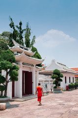 Buddhist monk walking pass the gate of Wat Ratchaorotsaram  Bangkok