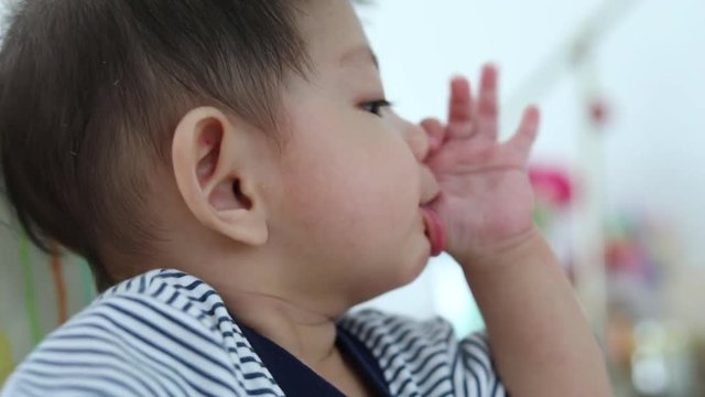 baby sucking finger hand
