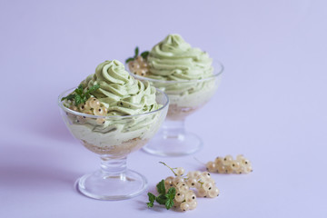 Mascarpone cream with tea matcha, savoiardi and white currants.