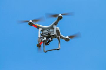 drone quadcopter with digital camera on the sky
