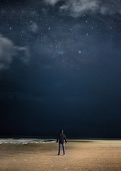 Fototapeta na wymiar A man by the ocean at night