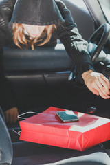Burglar thief stealing smartphone and bag from car