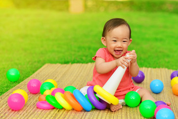 Fototapeta na wymiar Cute Asian baby playing with toys in playground 
