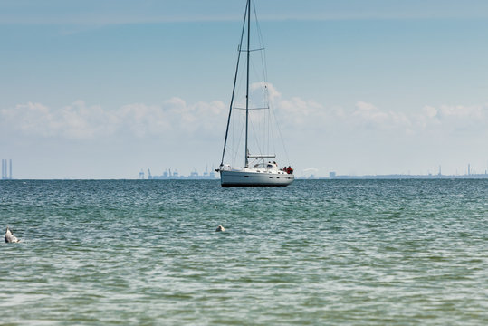 Yacht sail boat on calm sea water