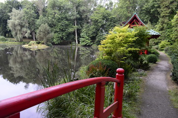 Beautiful Japanese-style garden with red pagoda and bridge 