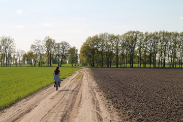 Obraz premium Countryside road and bicyclist