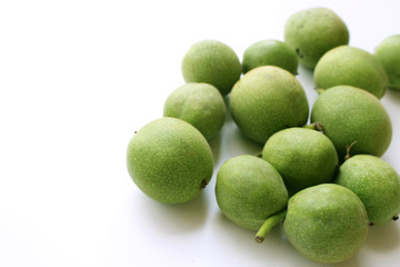 Young fruit of the walnut isolated on a white background.Vegetarian food.