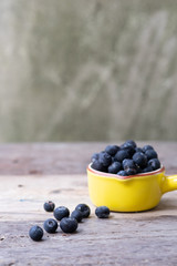 yellow bowl of blueberries