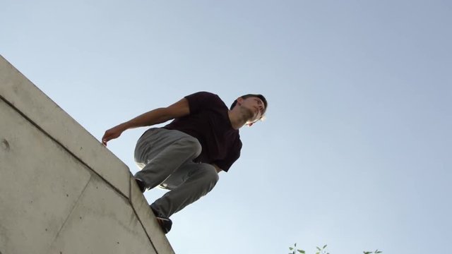 Freerunner jumping from one high wall to the next in  slow-motion. 