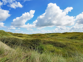 Obraz premium Rolling dunes and beautiful cloudy skies on the island Ameland