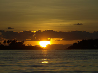 Naklejka na ściany i meble Sunset with tropical island 