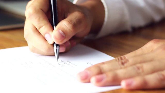 Businessman signing a document in office