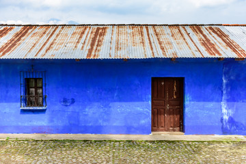 Fototapeta na wymiar Typical painted house with tin roof in village in Guatemala