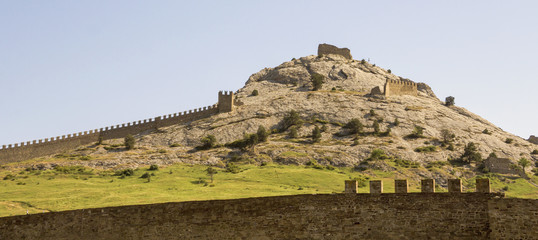 The stone walls of an ancient Genoa fortress located on the hill in the town of Sudak.Crimea.