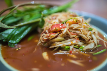 Somtum, papaya salad, famous Thai food close up with stricky rice