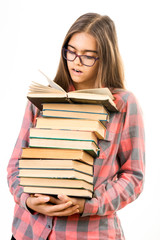 Girl with many books. A student holds a large stack of books. Ubcheba at school. Library. Beginning of studies at the Institute. Young girl with a book in glasses
