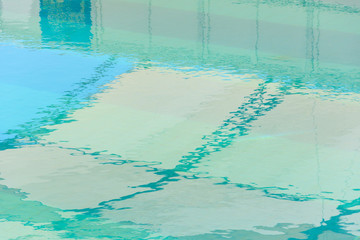 blue water surface in the pool with ripples and reflection