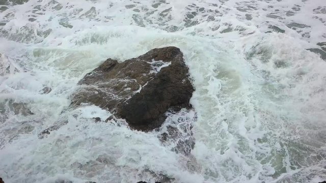 Slow motion shot from above of El Nino driven heavy surf crashing over rocks near Ocean Beach in San Francisco.