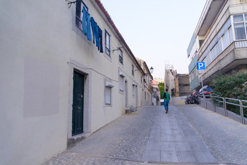 Fototapeta premium A view from the streets of Lisbon, Portugal, with a man how are going home