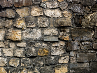 The texture of a stone fence made of granite. Background