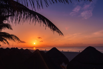 Fototapeta na wymiar A palapa hut on the beach at sunset in Playa del Carmen Mexico