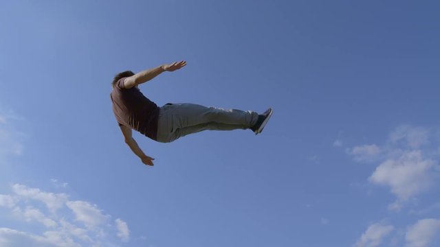 low shot of Freerunner is jumping through the air