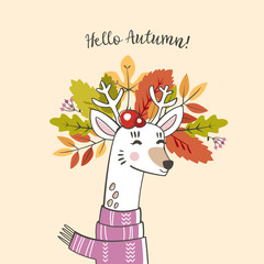 a cute deer with horns with a wreath of autumn leaves and berries on his head with the inscription hello autumn and the scarf around his neck