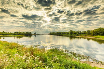 River landscape Millingerwaard at sunrise with overflow basins high water  floodplain forests and...