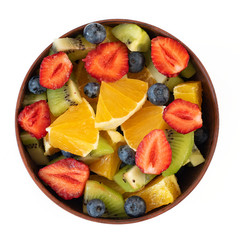 Bowl of healthy fresh fruit salad isolated on white background. Top view