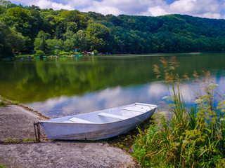 Obraz premium Wooden pier or jetty and a boat on lake sunset and sky reflection water.