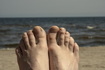 young woman enjoying beach, look of feet