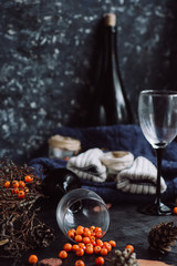  wine in glasses ,red berries,bumps and autumn branches on dark table. Autumn or Winter concept.