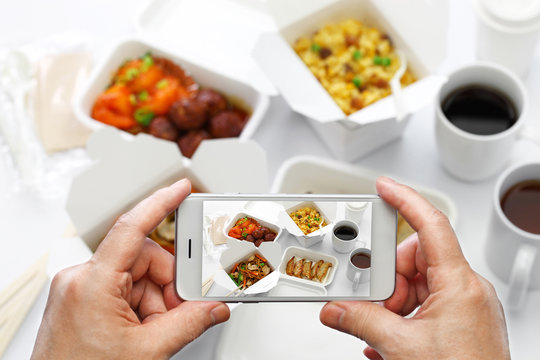 taking a photo of chinese take out food with smartphone