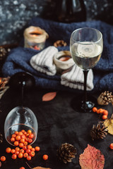  wine in glasses ,red berries,bumps and autumn branches on dark table. Autumn or Winter concept.