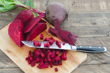 Beet cut into cubes on kitchen board.