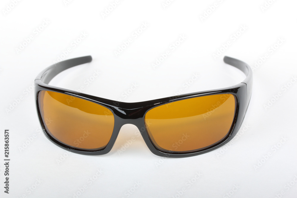 Wall mural Sunglasses with black plastic frame and yellow glass on a white background