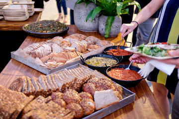 People group catering buffet food outdoor in luxury restaurant. Catering food party at restaurant, mini canapes, snacks and appetizers, wedding food