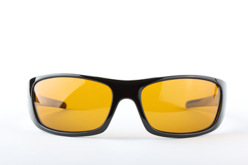 Fototapeta premium Sunglasses with black plastic frame and yellow glass on a white background