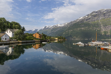 Fototapeta na wymiar View of Sor fjord from Lofthus with a beautiful reflection of mountains in the background