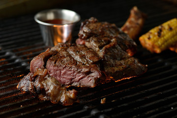 Grilled meat with vegetables and sauce, on the grill