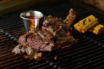 Grilled meat with vegetables and sauce, on the grill