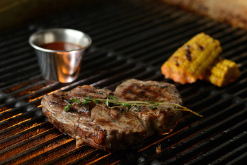 Grilled meat with vegetables and sauce, on the grill