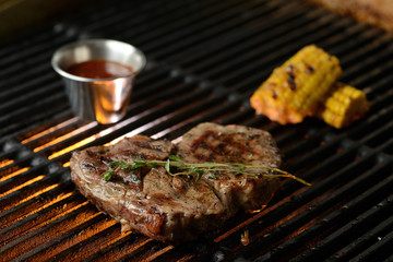 Grilled meat with vegetables and sauce, on the grill