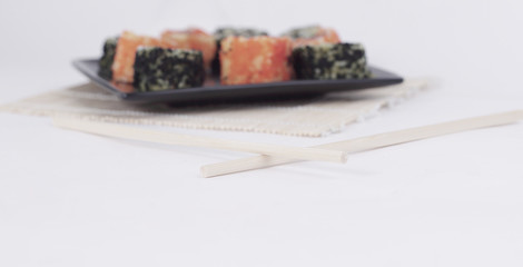 different types of Maki sushi on a black plate