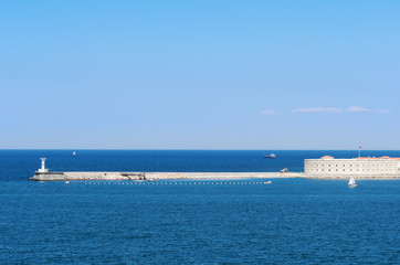 Russia, the peninsula of Crimea, the city of Sevastopol. 06/10/2018: Konstantinovskaya battery and a lighthouse at the entrance to the Sevastopol Bay