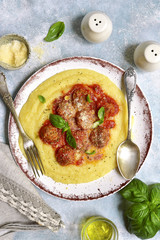 Polenta with meatballs in tomato sauce.Top view.